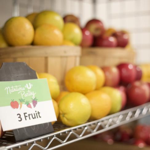 Baskets of fruit sit on the shelves of the Nutritious U food pantry